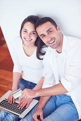 Image showing relaxed young couple working on laptop computer at home