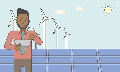 Image showing Man with solar panels and wind turbines.