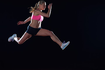 Image showing Athletic woman running on track