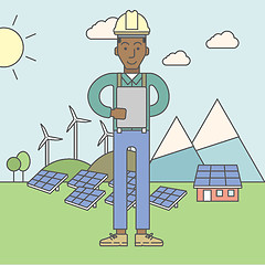 Image showing Man with solar panels and wind turbines.