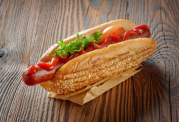 Image showing Hot dog on wooden table