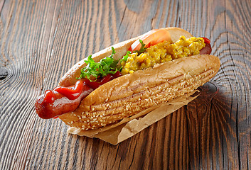 Image showing Hot dog on wooden table