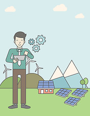 Image showing Man with solar panels and wind turbines.