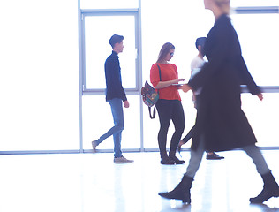 Image showing student girl standing with laptop, people group passing by