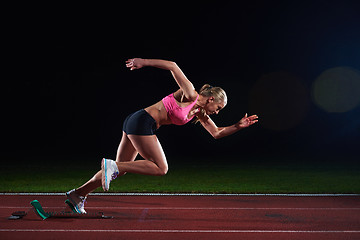 Image showing pixelated design of woman  sprinter leaving starting blocks