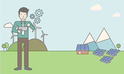 Image showing Man with solar panels and wind turbines.