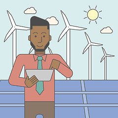 Image showing Man with solar panels and wind turbines.