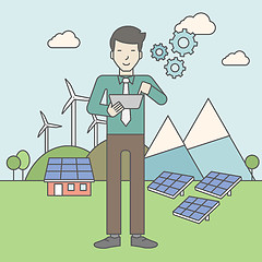 Image showing Man with solar panels and wind turbines.