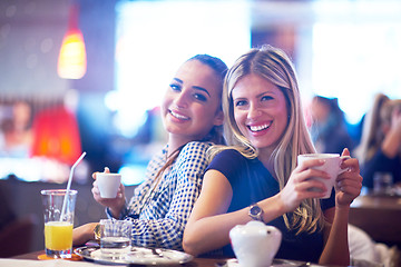 Image showing girls have cup of coffee in restaurant