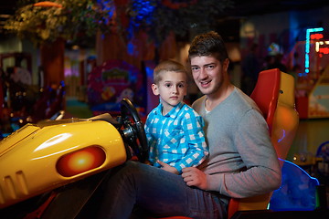 Image showing father and son playing game in playground