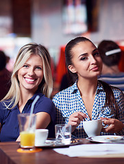 Image showing girls have cup of coffee in restaurant