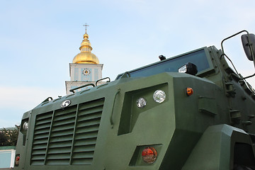 Image showing Military vehicle close-up against the church bell tower