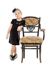 Image showing Little Girl Standing near Antique Chair