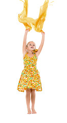 Image showing Little Girl in a Yellow Dress throws up Shawl