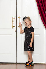 Image showing Little Girl in Evening Dress Standing near Door