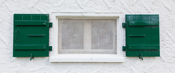 Image showing Open wooden  green shutters