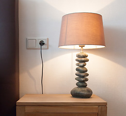 Image showing Modern table lamp on a bedside table