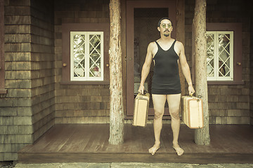 Image showing Gentleman Dressed in 1920’s Era Swimsuit Holding Suitcases on 