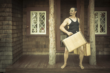 Image showing Gentleman Dressed in 1920’s Era Swimsuit Holding Suitcases on 