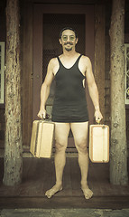 Image showing Gentleman Dressed in 1920’s Era Swimsuit Holding Suitcases on 