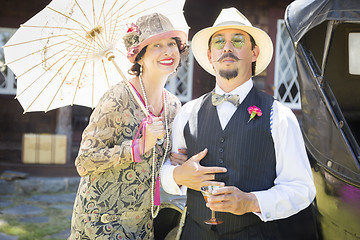 Image showing Mixed-Race Couple Dressed in 1920’s Era Fashion Sipping Champa