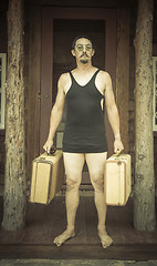 Image showing Gentleman Dressed in 1920’s Era Swimsuit Holding Suitcases on 