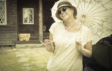 Image showing 1920s Dressed Girl with Parasol Near Vintage Car Portrait