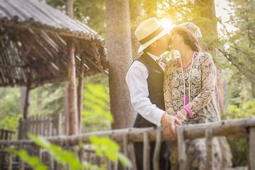 Image showing 1920s Dressed Romantic Couple Kissing on Wooden Bridge