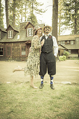 Image showing 1920s Dressed Romantic Couple in Front of Old Cabin