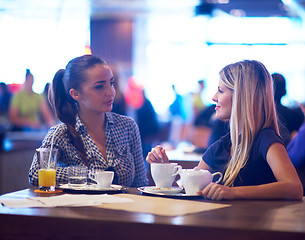 Image showing girls have cup of coffee in restaurant