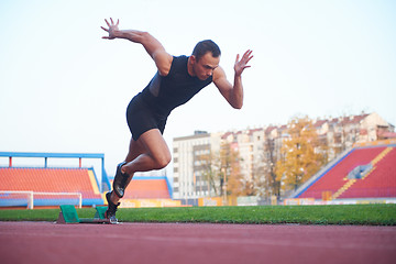 Image showing pixelated design of woman  sprinter leaving starting blocks