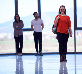 Image showing student girl standing with laptop, people group passing by