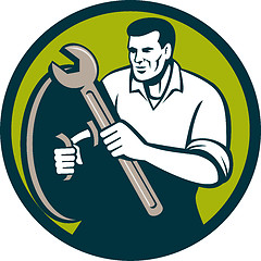 Image showing Mechanic Brandishing Spanner Wrench Circle Retro