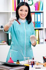 Image showing Female doctor analyzing a blood