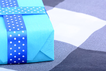 Image showing blue gift box with white ribbon