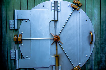 Image showing security vault door on green wall