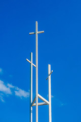 Image showing Three trinity White Christian crosses in front of a cloudy sky w