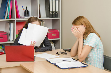 Image showing The girl was crying at the reception office worker covered his face with papers