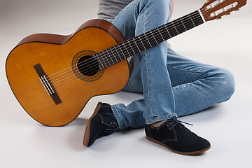 Image showing Man\'s Legs And Guitar