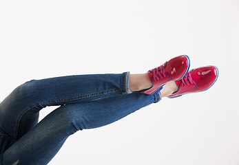 Image showing Woman\'s Legs In Blue Jeans And Red Shoes