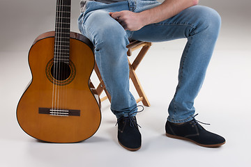 Image showing Man\'s Legs And Guitar