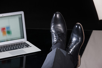 Image showing Man\'s Legs And Notebook