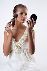 Image showing Young Woman Applying Cosmetics
