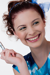 Image showing Young Woman Applying Cosmetics