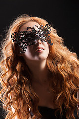 Image showing Young Red- Haired Woman In A Black Mask