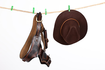 Image showing Cowboy Hat and Belt On A Clothesline