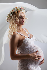 Image showing Young Pregnant Woman With Flower Garland