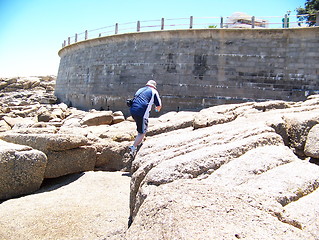 Image showing Man climbing on rocks