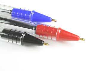 Image showing three different coloured ball point pens