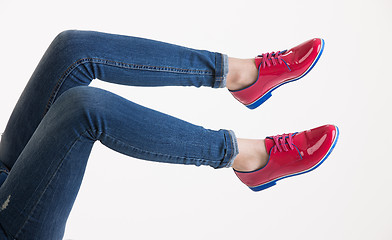 Image showing Woman\'s Legs In Blue Jeans And Red Shoes